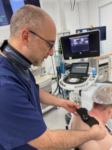 Dr. Bart Billet placing the EcoAI™ device on a patient as part of clinical pain therapy.