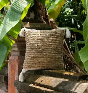 Rattan chair outdoor with soft cushions in garden setting