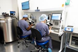 Embryologists at RMA of New York working in the IVF laboratory, conducting procedures under microscopes within a controlled lab environment.