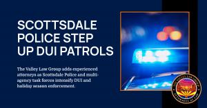 Scottsdale police SUV with flashing lights on a downtown street at night during a DUI patrol.