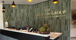 Reception area with wall signage reading “The Valley Law Group — Attorneys at Law.”