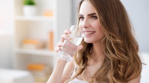 Woman drinking well water that went through an iron filter