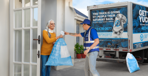 SkipTheDepot driver picking up bottles from a Calgary doorstep.