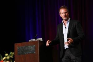 Shane Krider presenting on stage at a Prosperity Of Life event in Seattle, inspiring entrepreneurs with strategies for mindset mastery and financial freedom.