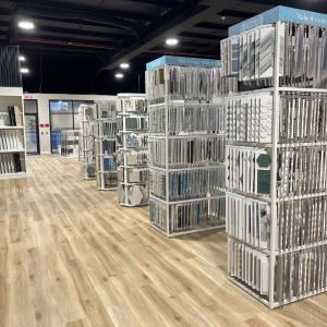 Interior of Tile Factory Direct Gainesville showroom with aisles of tile sample racks and displays.
