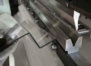 Clear polycarbonate sheet being bent on a press brake.