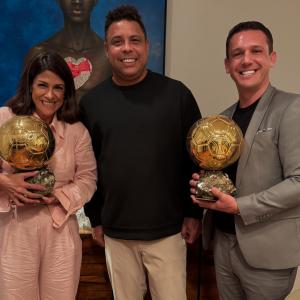 Rony Jabour, his wife Carolline Jabour, and Brazilian soccer legend Ronaldo Nazário smile while holding Ronaldo’s Ballon d’Or trophies during a private dinner in São Paulo, Brazil, October 2025.