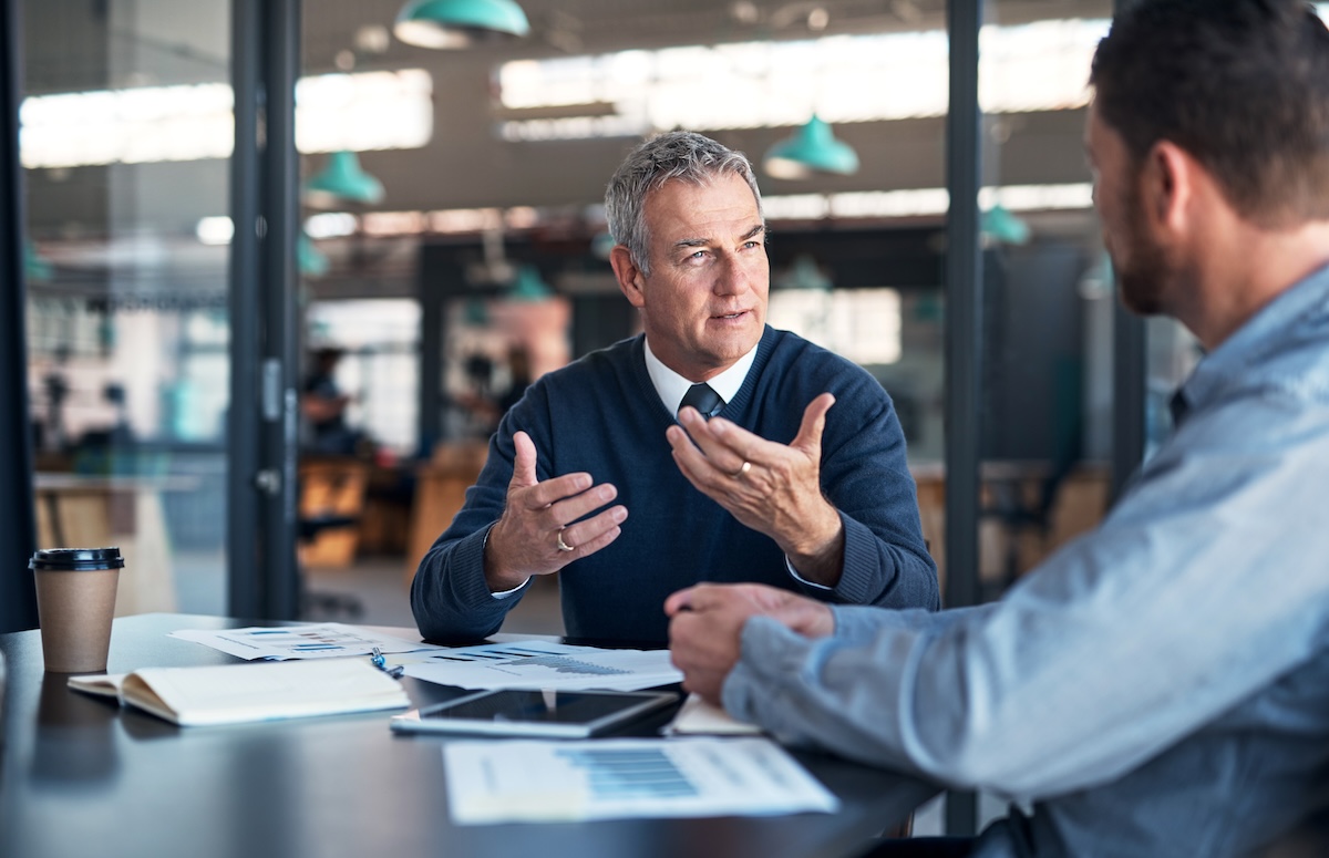 Financial Advisor meeting with Client in conference room