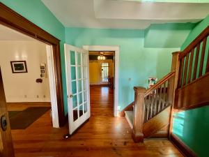 The home measures 2,372 +/- gross sf. (1,956 +/- sf. of living space & 416 +/- sf. basement) and has one bathroom on the main level, 3 bedrooms & one bathroom on the 2nd level, and 2 bedrooms on third level.  It features an short walk to Main Street