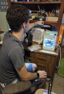 A touching scene: an autistic child discovering joy through 3D printing.