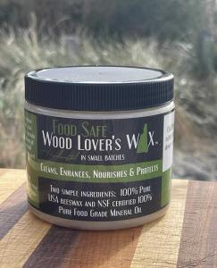 Wood Lover’s Wax Food Safe Wax jar displayed on a striped wooden board with natural background.