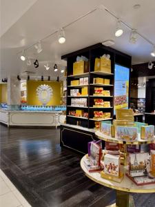 Bissinger’s Handcrafted Chocolatier boutique inside Macy’s Herald Square on the 6th floor, featuring a candy case, elegant chocolate displays, and beautifully arranged gift bags