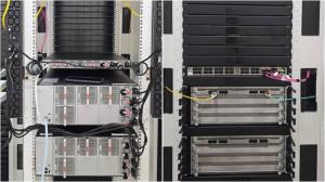 Front and rear view of a server rack with 4U network switches in operation, part of MIRhosting’s upgraded 400G ZR+ infrastructure in Amsterdam.