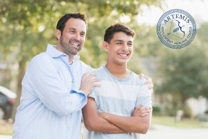 A father and son embrace happily to show to the concept of of teen treatment programs at Artemis in Tucson