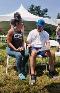 Dr. Kevin Greene, founder of Confidia Health, discusses ANS Pulse Wave Analysis results with an athlete at the Factory Summer Slam CrossFit event in Southington, Connecticut.