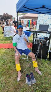 Dr. Kevin Greene, founder of Confidia Health, smiles while undergoing ANS Pulse Wave Analysis testing at the MetaLab by Confidia booth during Factory Summer Slam in Southington, Connecticut.