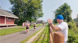 Dr. Kevin Greene, founder of Confidia Health, cheers on athletes running in the Factory Summer Slam CrossFit competition in Southington, Connecticut.