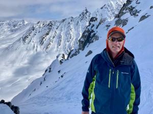 Gary Fraser, Mount Everest Base Camp Expeditioner for the Sophia Ruggieri Memorial Foundation, shown in front of snowy Mount Everest.