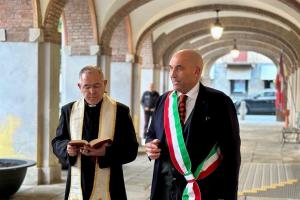 View of the cloister at the Abbazia di Santa Giustina with clergy and officials participating in the centennial ceremony for Count Giuseppe Frascara.