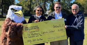 Cooper Hurley Injury Lawyers presents $10,000 to St. Matthew's Catholic School.