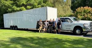 Here To There Moving LLC truck and moving crew posing for a photo before a residential move.