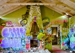 graffiti on fireplace in abandoned dwelling