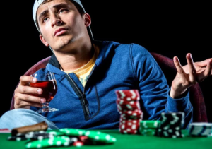 Man in baseball hat gambling at a casino table