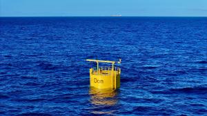 A cylindrical structure floating in the ocean with 'DON' emblazoned across the front