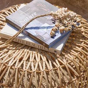 Outdoor side table beside rattan lounge chairs