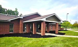 Picture of outside on Neighborhood Roofing's New Location  showing a red brick building