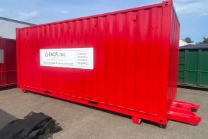 Bright red container that has a sign on it
