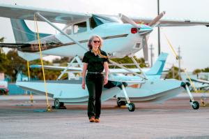 Georgette Poulos, Executive Business Manager for Sun City, in front of Seaplane