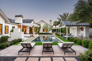 Resort-style private pool and spa, surrounded by travertine patio, with a large covered outdoor entertaining area and built-in barbecue in the luxury Arcadia estate.