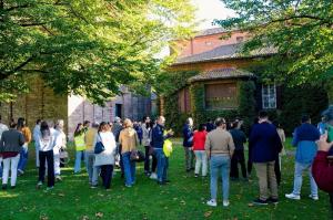 Community and visitors in the courtyard of Santa Giustina Abbey in Sezzadio, cultural heritage event under autumn light.