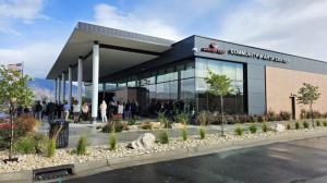 Picture of a building with the name Canyon View Credit Union Community and Arts Center  on the side and people gathered to attend the renaming.