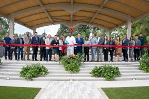 CIty of Carson Council, Executive Team, Directors and APL Architect Tony Lawson posed for a picture holding a ribbon for the ribbon cutting at the front of the new amphitheater stage