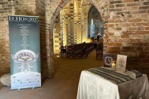 Entrance of the Abbey of Santa Giustina, Villa Badia Sezzadio, showing the Echos International Music Festival 2025 banner and welcome table, symbolising the site’s heritage and its cultural partnership supported by Dazhun Zhang.