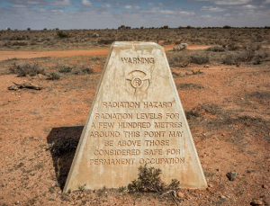 A memorial stone about the nuclear test at Maralinga stands as a reminder of what the military did on this land.
