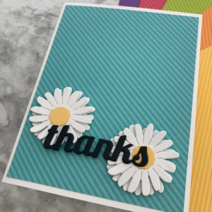 Beautiful handmade “Thanks” card crafted using 12x12 cardstock paper, showcasing layered textures and warm Thanksgiving-inspired colors.