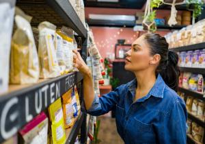 Mom at the supermarket checking the gluten free label