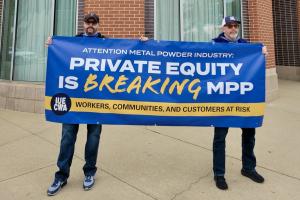 IUE-CWA Union workers protest Private Equity at Metal Powder Industry trade show in Chattanooga, Tenn., on October 26 outside the Chattanoogan Hotel by holding banner which states: Attention Metal Powder Industry: Private Equity Is Breaking MPP - Workers,
