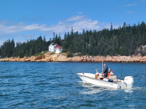 Patricia and Alan aboard their 1965 Boston Whaler Fritzie M. Rose near Bass Harbor Head Light Station in Maine. Photo by Paul Grindle.