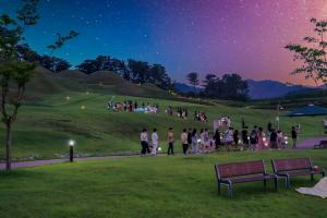 Visitors take part in a nighttime walking tour at the Seongsan-dong Ancient Tombs in Seongju, South Korea.