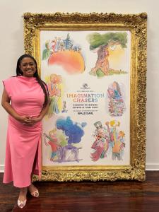 Melethia Tuggle, Founder and CEO of Robin Steel, at the Boys & Girls Clubs of Collin County’s 2025 Chrysalis Ball Imagination Chasers gala in Frisco, Texas, standing beside the Roald Dahl–inspired event artwork in a gold frame.