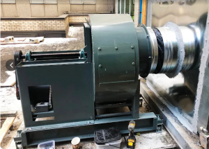Industrial HVAC blower unit installed on a commercial rooftop in Brooklyn, showing duct connection and housing used for building ventilation and heating systems
