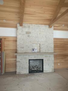 Custom indoor stone fireplace installation by Red Robin Masonry in Toronto