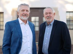 Conor A. Meyers and Lee Clark, co-founders of Clark Meyers PC, standing together outside their law office in professional business attire. The boutique business law firm serves Northern California and Idaho's Treasure Valley with Fortune 500-level legal e