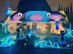 Nighttime exterior display featuring 100,000+ LED lights choreographed to the K-Pop Demon Hunters track “GOLDEN.”