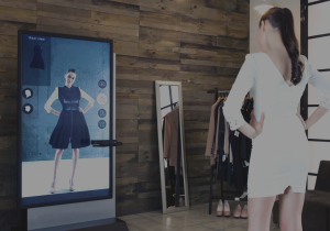 Visitor using Virtual On’s touchless Fashion Mirror to try on virtual outfits with no contact or email required.