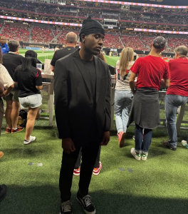MartynGBuckets, high-net-worth financial operator and founder of MGBSP Services, pictured at a soccer game reflecting his brand’s exclusivity and strategic focus.